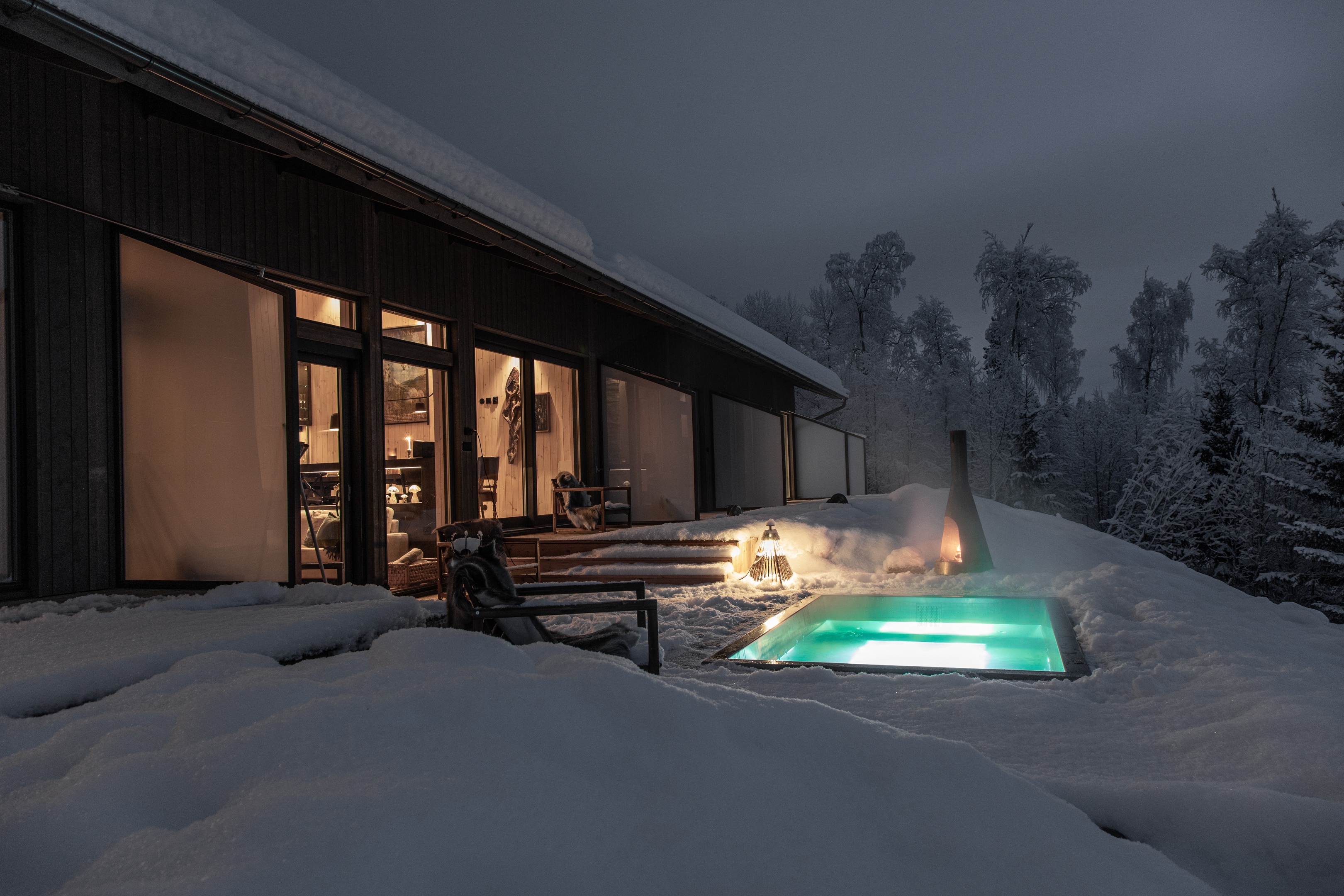 Snowy landscape, frozen trees and open water on the river